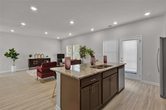 2766 Aralynn Way, College Park, GA 30337 - kitchen with appliances with stainless steel finishes, a sink, light wood-type flooring, light stone counters, and recessed lighting