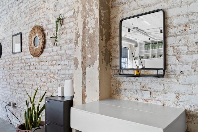 bathroom featuring brick wall