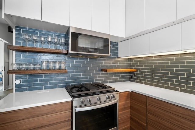 kitchen featuring backsplash, open shelves, stainless steel appliances, and modern cabinets