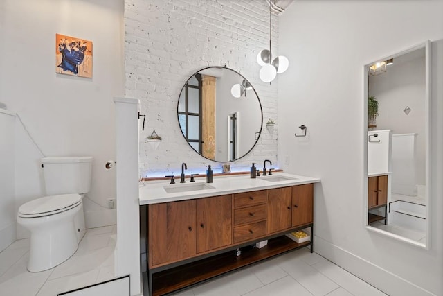 bathroom with a sink, toilet, and double vanity