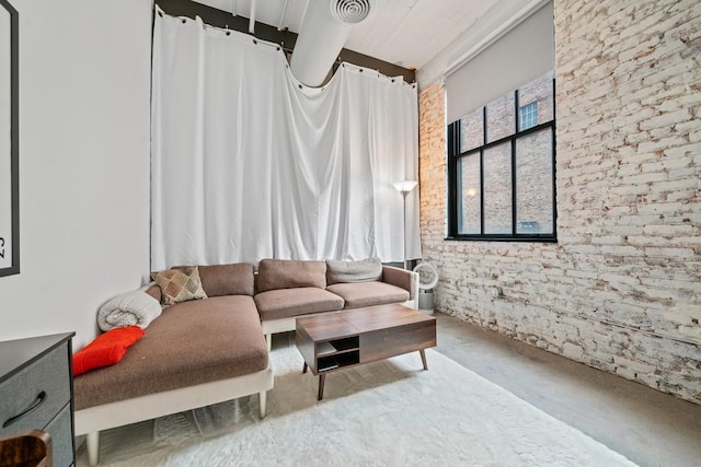 living area featuring visible vents and concrete floors