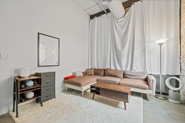 living area with concrete floors