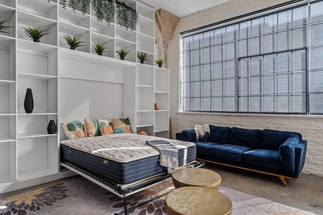 bedroom featuring concrete flooring