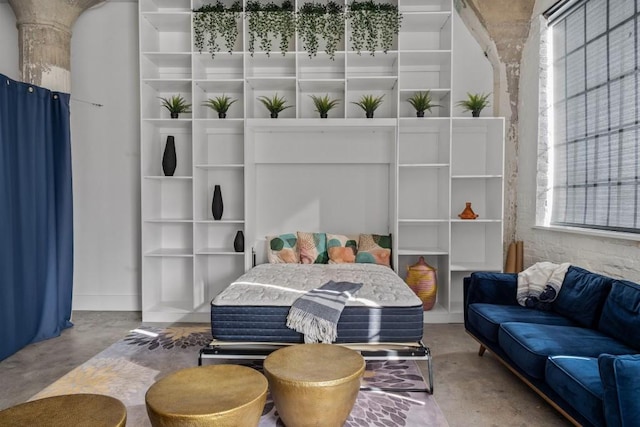 bedroom featuring concrete flooring