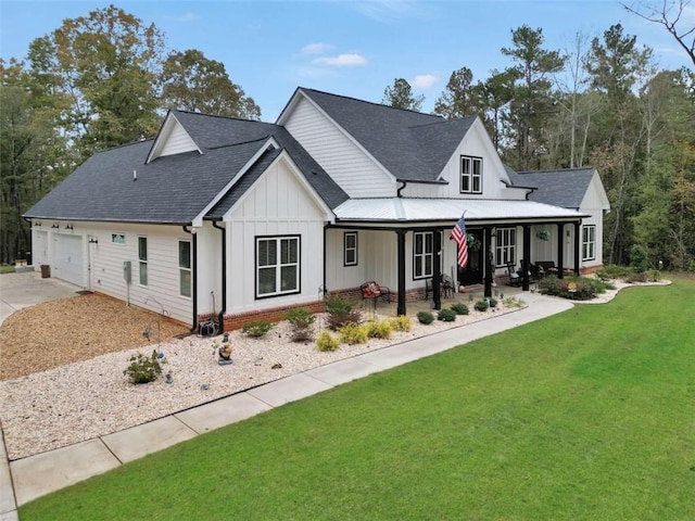 view of front facade with a porch, a garage, and a front lawn