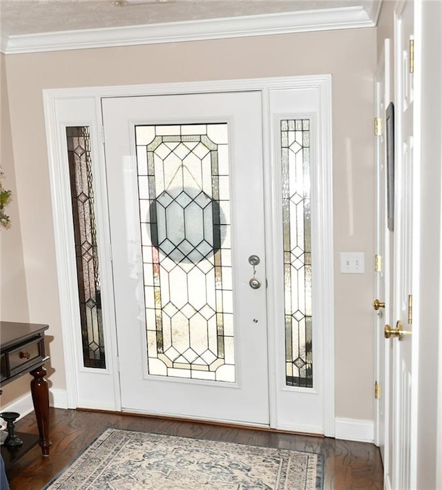 foyer entrance featuring ornamental molding and dark wood-type flooring