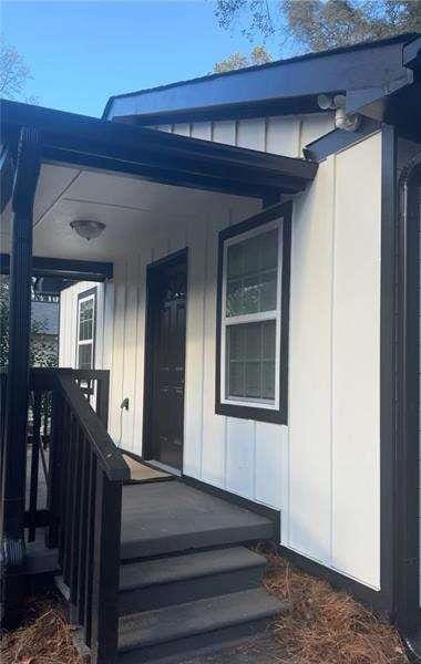 view of exterior entry with a porch