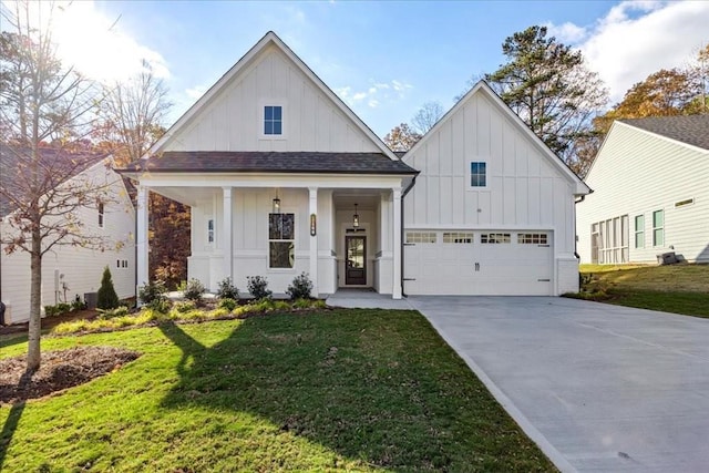 modern inspired farmhouse featuring a front yard and a garage