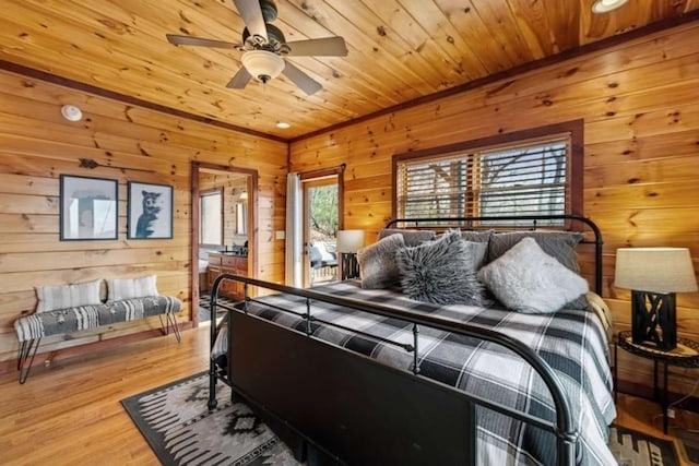bedroom with wood ceiling, wood walls, and light wood finished floors