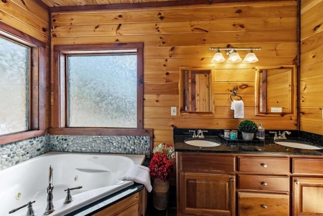 full bath with a jetted tub, wooden walls, and a sink