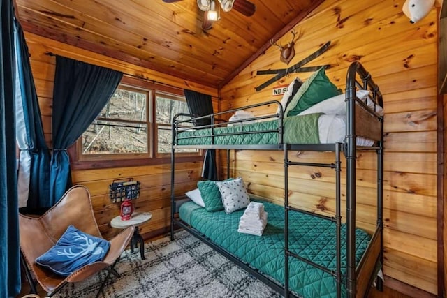 bedroom with lofted ceiling, wood ceiling, and wood walls