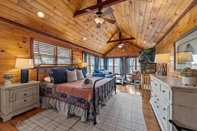 bedroom with light wood-style floors, wooden walls, wood ceiling, and vaulted ceiling