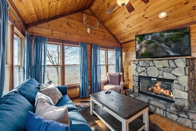 living room featuring wood finished floors, a healthy amount of sunlight, lofted ceiling, and ceiling fan