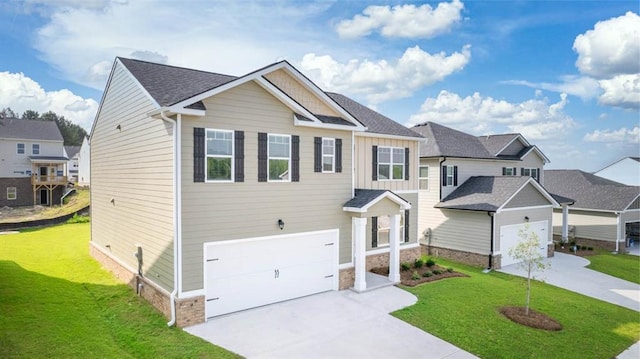 view of front of house featuring a front lawn and a garage