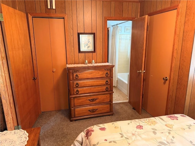 carpeted bedroom with wood walls