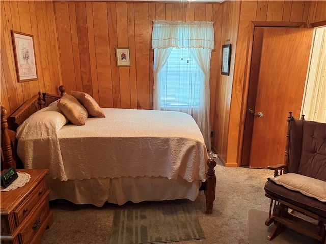 carpeted bedroom with wooden walls