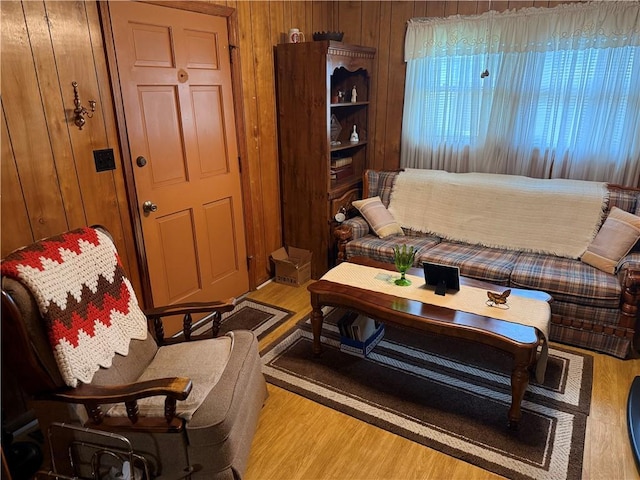 living area with wood finished floors and wood walls