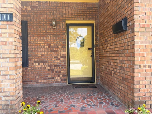 property entrance with brick siding