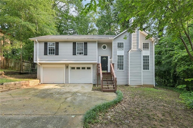 2920 Cushing Ct, Jonesboro, GA 30236 - bi-level home with driveway, an attached garage, and a chimney