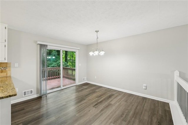 2920 Cushing Ct, Jonesboro, GA 30236 - unfurnished dining area with dark wood-style flooring, a chandelier, baseboards, and a textured ceiling
