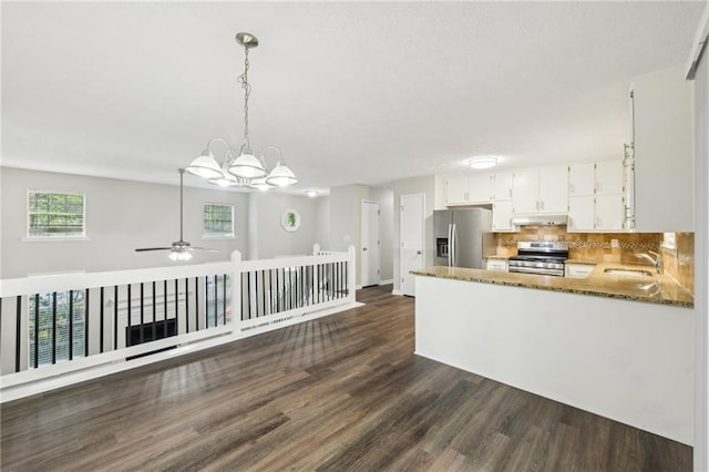 2920 Cushing Ct, Jonesboro, GA 30236 - kitchen featuring appliances with stainless steel finishes, dark wood-type flooring, white cabinetry, stone countertops, and tasteful backsplash