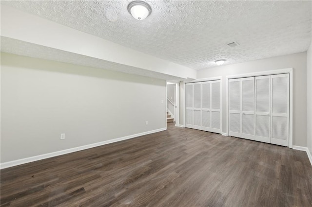 2920 Cushing Ct, Jonesboro, GA 30236 - finished below grade area with dark wood-style floors, baseboards, a textured ceiling, and stairway