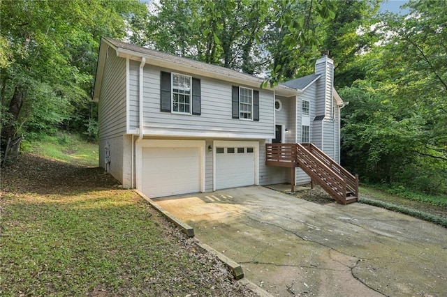 2920 Cushing Ct, Jonesboro, GA 30236 - bi-level home with a chimney, concrete driveway, a garage, and view of scattered trees