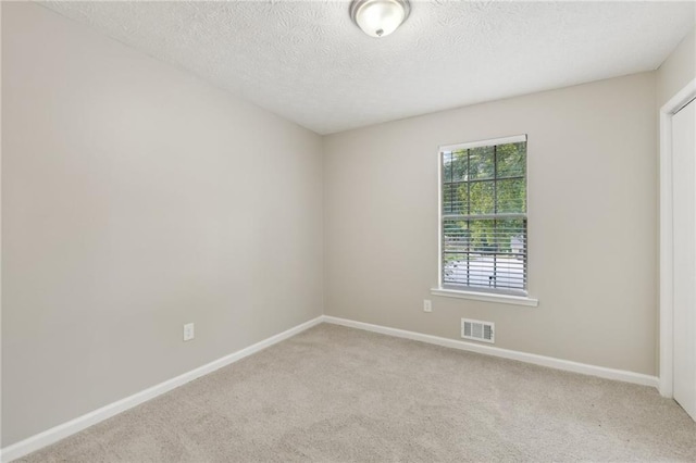 2920 Cushing Ct, Jonesboro, GA 30236 - spare room featuring light carpet, baseboards, and a textured ceiling