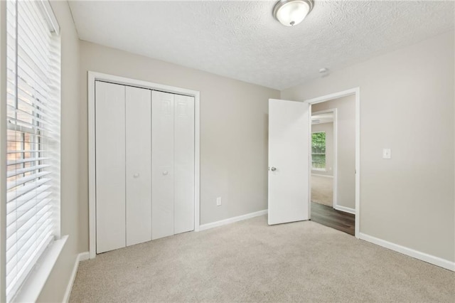 2920 Cushing Ct, Jonesboro, GA 30236 - unfurnished bedroom featuring carpet flooring, baseboards, a textured ceiling, and a closet