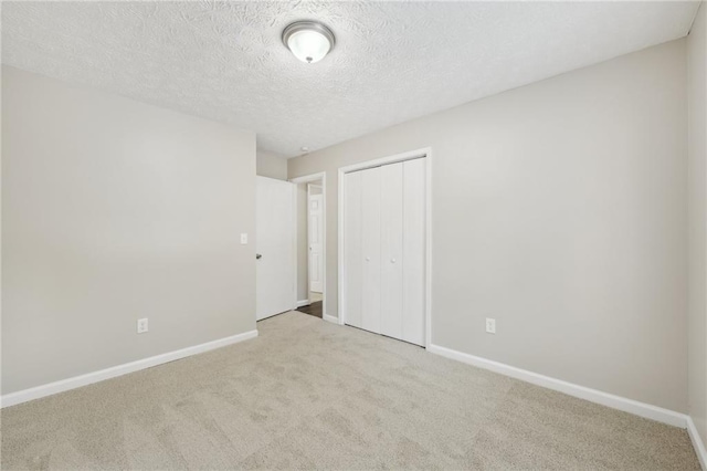 2920 Cushing Ct, Jonesboro, GA 30236 - unfurnished bedroom with a closet, baseboards, carpet flooring, and a textured ceiling