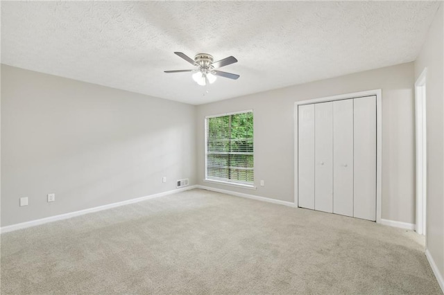 2920 Cushing Ct, Jonesboro, GA 30236 - unfurnished bedroom featuring baseboards, carpet, a textured ceiling, a ceiling fan, and a closet