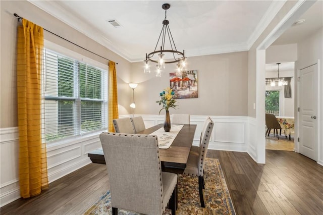 4266 Suwanee Brook Ct, Buford, GA 30518 - dining room with a chandelier, dark wood finished floors, ornamental molding, a wainscoted wall, and a decorative wall