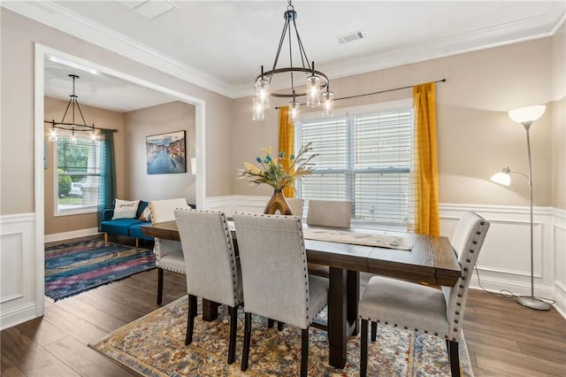 4266 Suwanee Brook Ct, Buford, GA 30518 - dining room featuring a chandelier, wainscoting, a decorative wall, wood finished floors, and ornamental molding