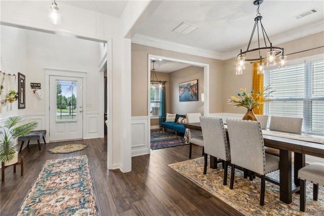 4266 Suwanee Brook Ct, Buford, GA 30518 - dining space featuring a chandelier, wainscoting, dark wood-type flooring, and ornamental molding