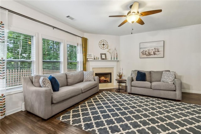 4266 Suwanee Brook Ct, Buford, GA 30518 - living room with dark wood-style floors, ceiling fan, a lit fireplace, and baseboards