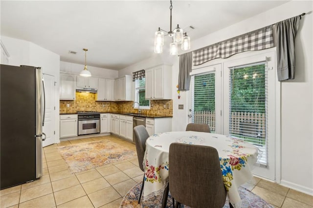 4266 Suwanee Brook Ct, Buford, GA 30518 - dining room with light tile patterned floors and a chandelier
