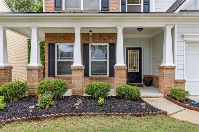 4266 Suwanee Brook Ct, Buford, GA 30518 - entrance to property with covered porch, brick siding, and a garage