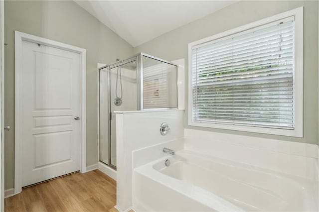 4266 Suwanee Brook Ct, Buford, GA 30518 - full bathroom with a bath, a shower stall, wood finished floors, and vaulted ceiling