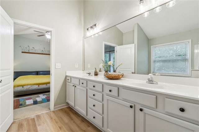 4266 Suwanee Brook Ct, Buford, GA 30518 - ensuite bathroom with double vanity, wood finished floors, vaulted ceiling, and a ceiling fan