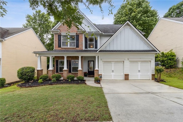 4266 Suwanee Brook Ct, Buford, GA 30518 - craftsman house featuring board and batten siding, brick siding, an attached garage, driveway, and covered porch