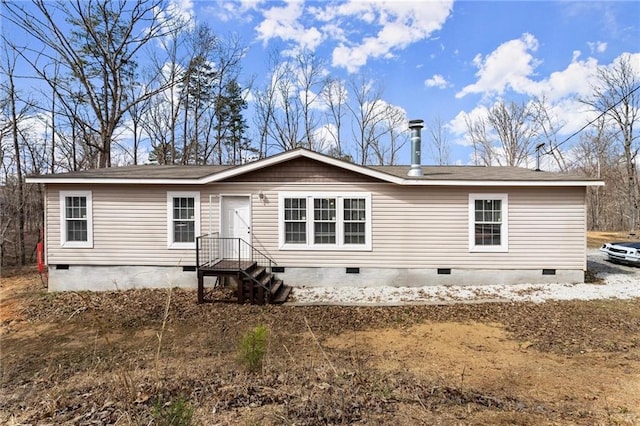 rear view of property featuring crawl space