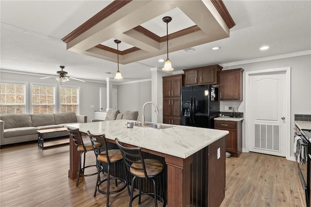 kitchen with open floor plan, visible vents, a sink, and black appliances