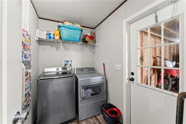 laundry room featuring ornamental molding, a textured ceiling, separate washer and dryer, wood finished floors, and laundry area