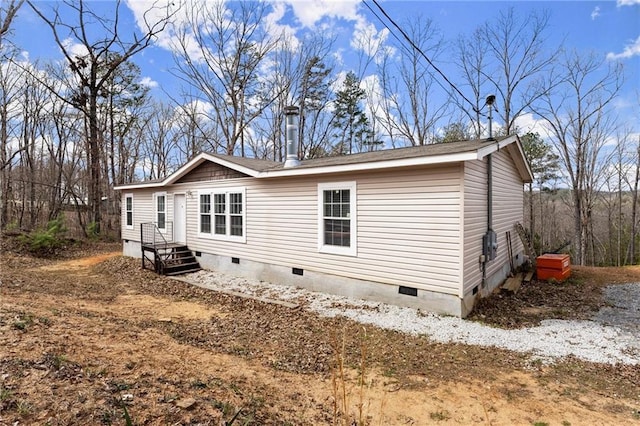 view of side of home featuring crawl space