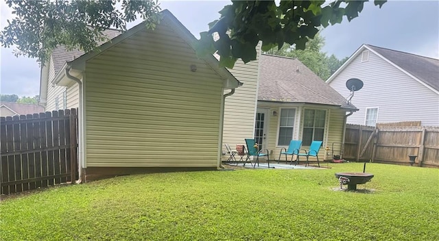 159 Misty Ridge Trl, Stockbridge, GA 30281 - back of property featuring a patio area and an outdoor fire pit
