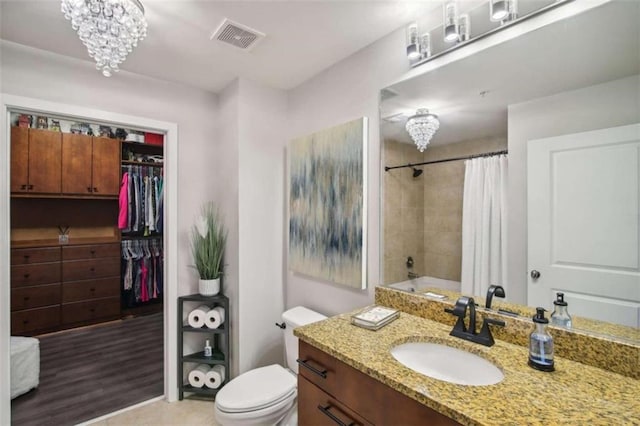 full bathroom with shower / bathtub combination with curtain, an inviting chandelier, tile patterned flooring, toilet, and vanity