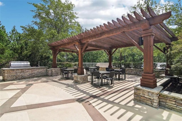 view of patio / terrace featuring an outdoor kitchen and a pergola