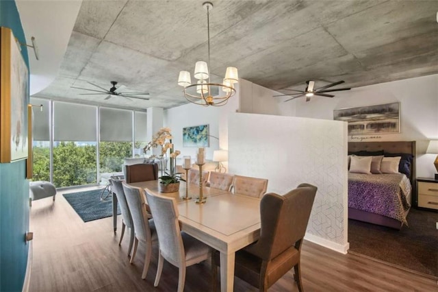 dining space with ceiling fan with notable chandelier, floor to ceiling windows, and wood-type flooring