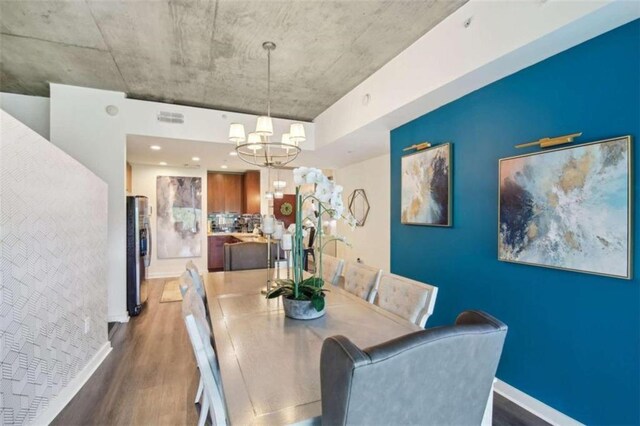 bedroom featuring a chandelier, light hardwood / wood-style floors, sink, and ensuite bath