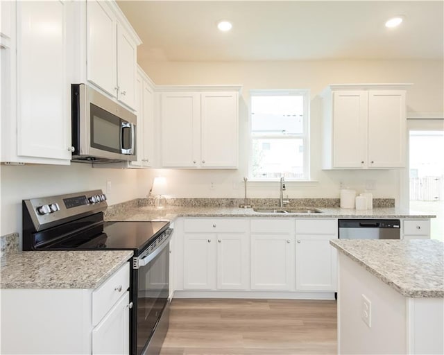 1577 Aiden Way Unit 39, Conyers, GA 30013 - kitchen featuring stainless steel appliances, a sink, white cabinetry, light wood finished floors, and recessed lighting